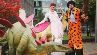 Helter Skelter Flintstones theme stilt walkers