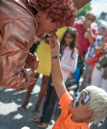 Living statue playing with child