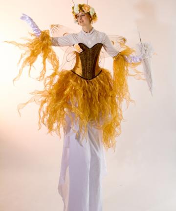 Gold fairy on stilts