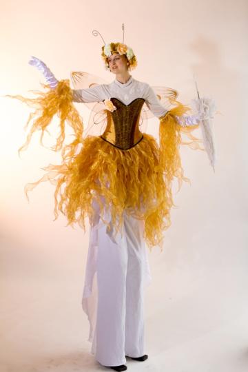 Gold fairy on stilts