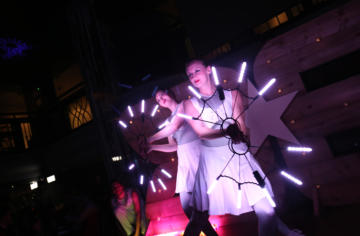2 performers spinning LED lights