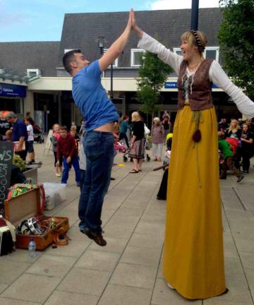 Medieval stilt walker high five