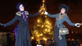 Victorian christmas stilt walkers